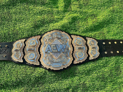 AEW championship belt on a grassy background