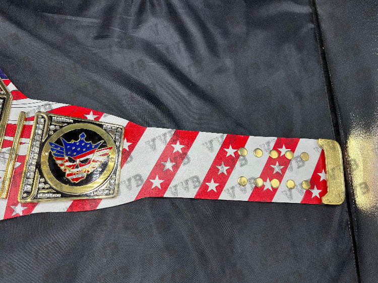 Close-up of the belt’s gold center plate engraved with Cody Rhodes’ name and championship design.