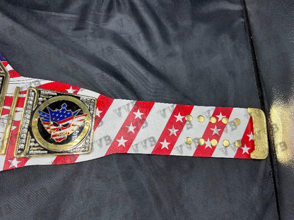 Close-up of the belt’s gold center plate engraved with Cody Rhodes’ name and championship design.