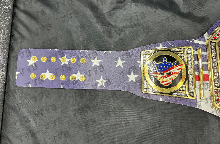 Close-up of the belt’s gold center plate engraved with Cody Rhodes’ name and championship design.