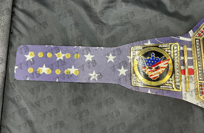 Close-up of the belt’s gold center plate engraved with Cody Rhodes’ name and championship design.