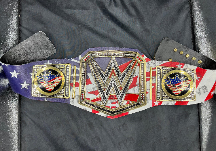 Close-up of the belt’s gold center plate engraved with Cody Rhodes’ name and championship design